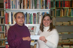 CASA Book ReViews Accountant Judith Bartel (on left) presents a check to Libby Schrag Oswald, Director of OVM.