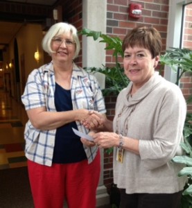 2013july21 Book ReViews board member LaDeen Frey (L) hands check to Mary Beasley of USD273